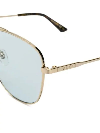 Shop Gucci Navigator Sunglasses In Gold