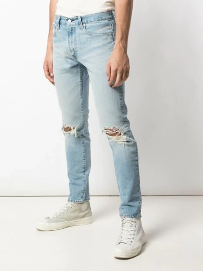 Shop Levi's Ripped Detail Tapered Jeans In Blue