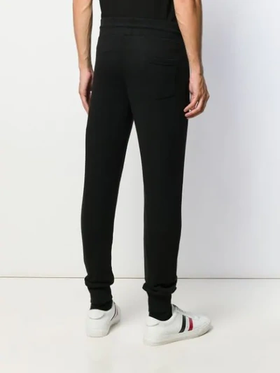 Shop Moncler Logo Print Track Pants In 999 Black