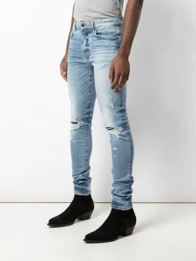 Shop Amiri Distressed Skinny Jeans In Blue
