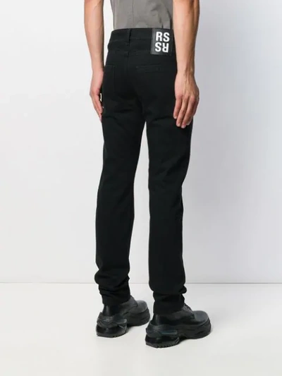Shop Raf Simons Embroidered Text Jeans In Black