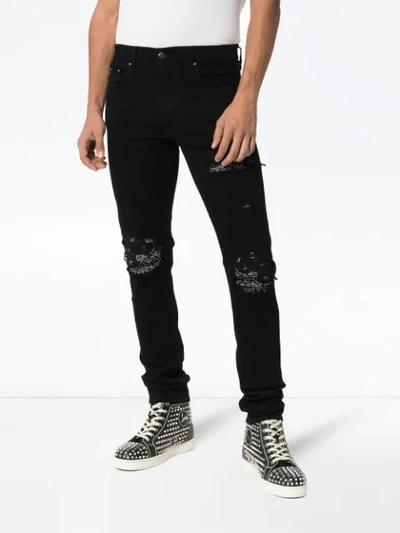 Shop Amiri Distressed Skinny Jeans In Black