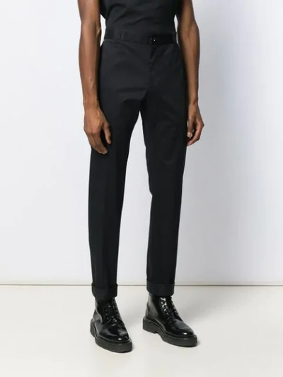 Shop Versace Tapered Chino Trousers In Black