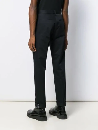 Shop Versace Tapered Chino Trousers In Black