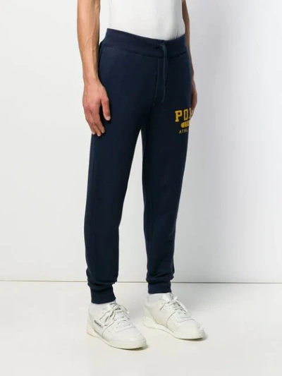 Shop Polo Ralph Lauren Logo Print Track Pants In Blue