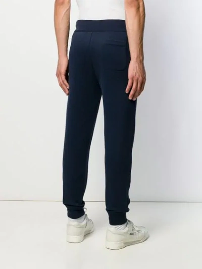 Shop Polo Ralph Lauren Logo Print Track Pants In Blue