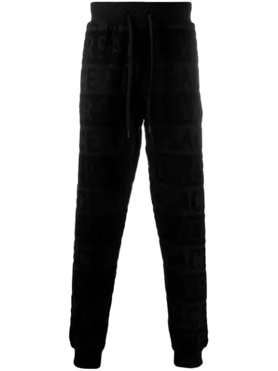 Shop Versace All Over Logo Track Trousers In Black