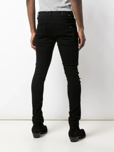 Shop Amiri Crystal Patch Distressed Skinny Jeans In Black