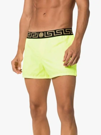 Shop Versace Logo-waist Swim Shorts In Yellow