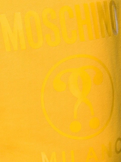 Shop Moschino Tonal Logo Print Track Pants In Yellow
