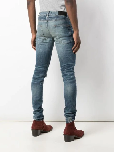 Shop Amiri Ripped Skinny Jeans In Blue