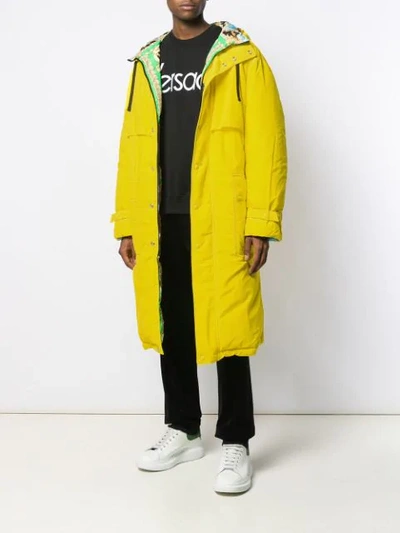 Shop Versace Hooded Belted Raincoat In Yellow
