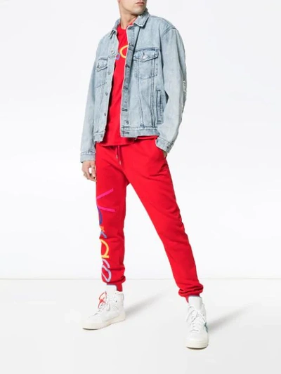 Shop Versace Logo Embroidered Cotton Track Pants In Red