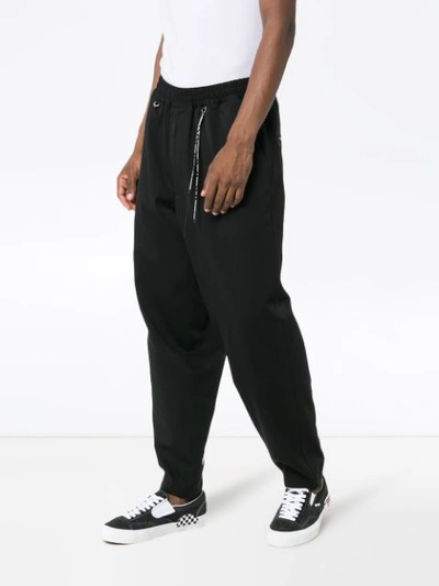 Shop Mastermind Japan Logo Print Tapered Track Pants In Black