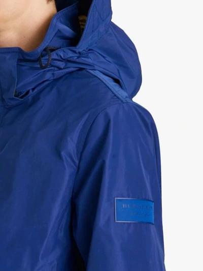 Shop Burberry Packaway Hood Rain Jacket - Blue