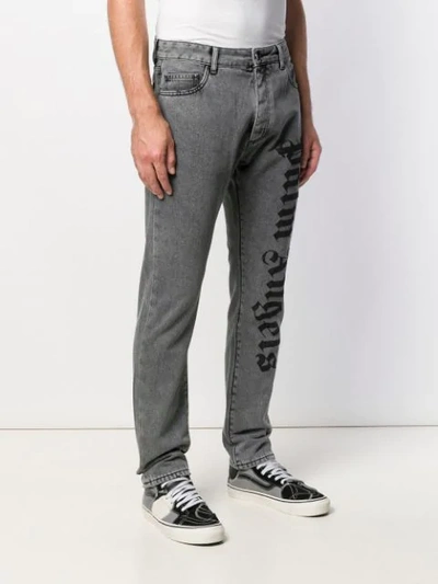 Shop Palm Angels Logo Print Jeans In Grey