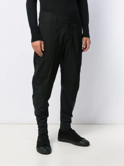 Shop Issey Miyake Tapered Leg Trousers In Black