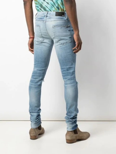 Shop Amiri Distressed Skinny Jeans In Blue