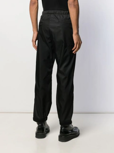 Shop Prada Elasticated Waist Strap Trousers In Black