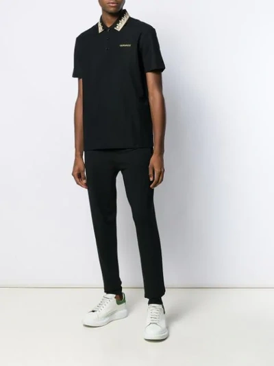 Shop Versace Contrasting Embroidery Polo Shirt In Black