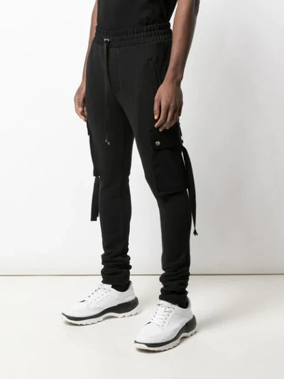 Shop Amiri Tapered Track Pants In Black