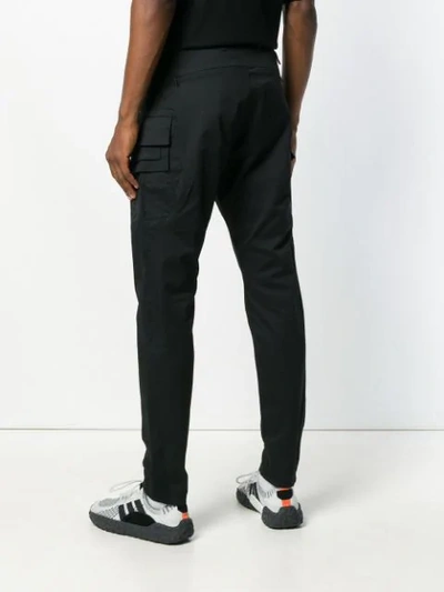 Shop White Mountaineering Slim-fit Trousers - Black
