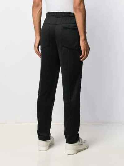Shop Puma Side Stripe Track Pants In 01 Black