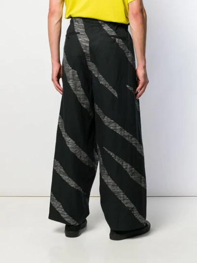 Shop Issey Miyake Striped Loose Trousers In Black