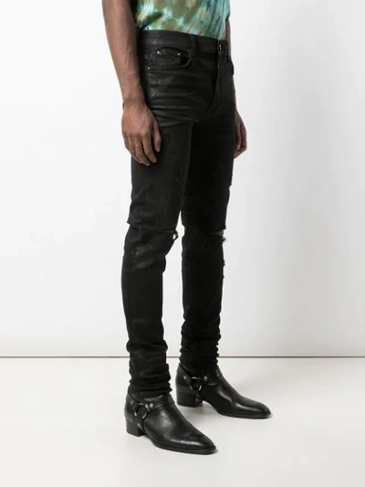 Shop Amiri Trasher Distressed Jeans In Black