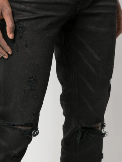 Shop Amiri Trasher Distressed Jeans In Black
