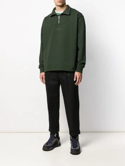 Shop Acne Studios Inverted Logo Zipped Polo Sweater In Green