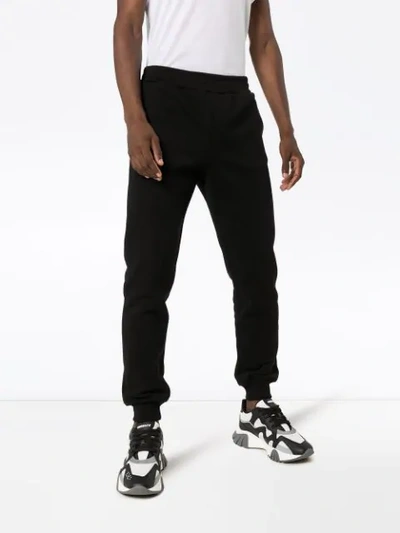 Shop Versace Logo Track Pants In Black