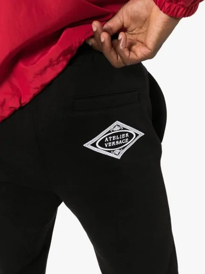 Shop Versace Logo Track Pants In Black