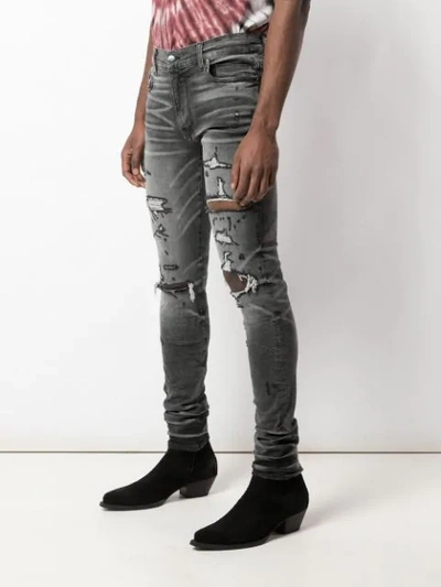 Shop Amiri Distressed Skinny Jeans In Black