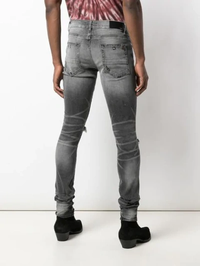 Shop Amiri Distressed Skinny Jeans In Black