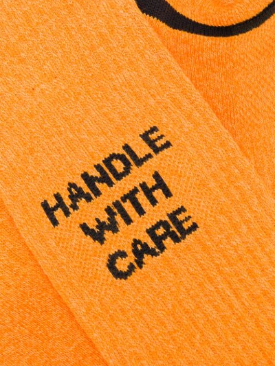 Shop Necessary Anywhere Handle With Care Socks In Orange