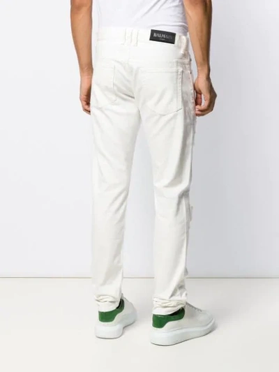 Shop Balmain Distressed Slim-fit Jeans In White