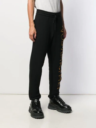 Shop Moschino Embroidered Logo Track Pants In Black