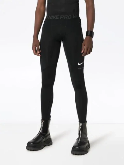 Shop Nike Logo Print Leggings In Black