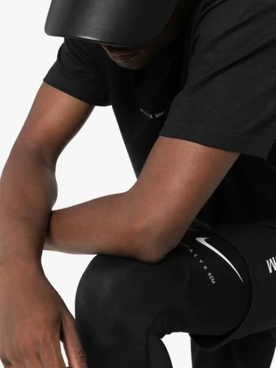 Shop Nike Logo Print Leggings In Black