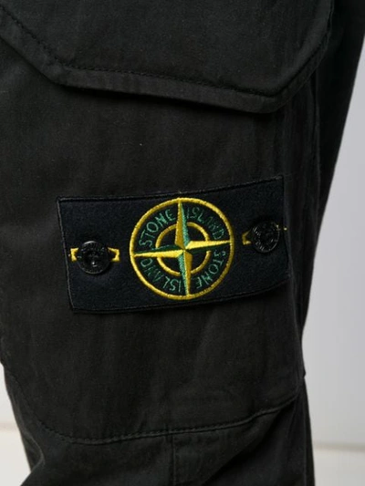Shop Stone Island Logo Patch Trousers In Black