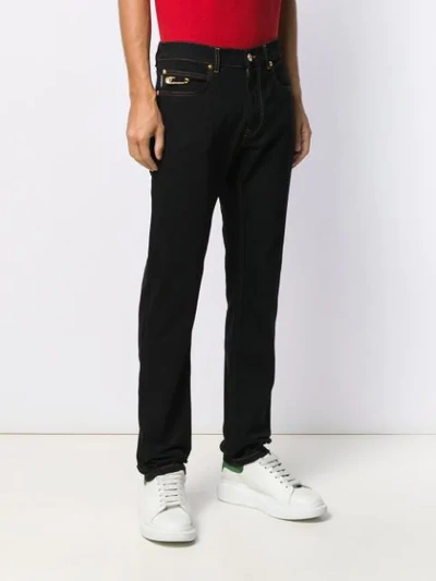 Shop Versace Flared Safety-pin Jeans In Black