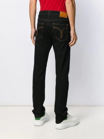 Shop Versace Flared Safety-pin Jeans In Black