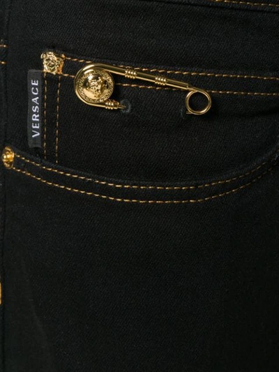 Shop Versace Flared Safety-pin Jeans In Black