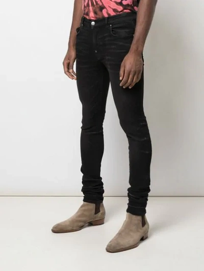 Shop Amiri Stack Skinny Jeans In Black