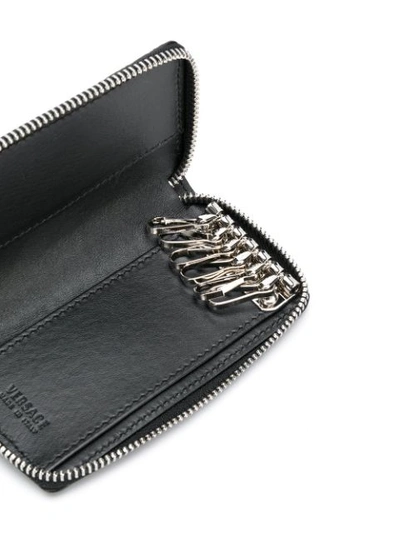 Shop Versace Embossed Zip Around Key Case - Black