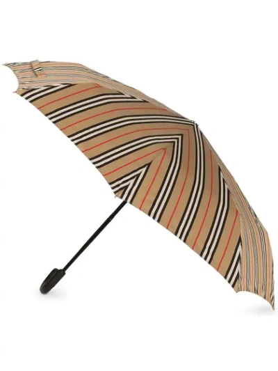 Shop Burberry Icon Stripe Folding Umbrella In 108 - Multicoloured