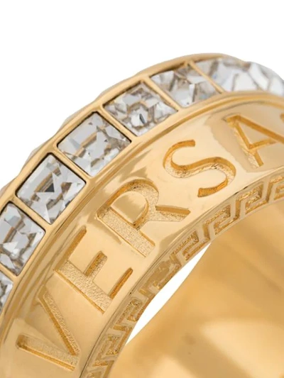 Shop Versace Crystal Logo Ring In Gold