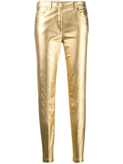 Shop Moschino Metallic Slim-fit Trousers In Gold