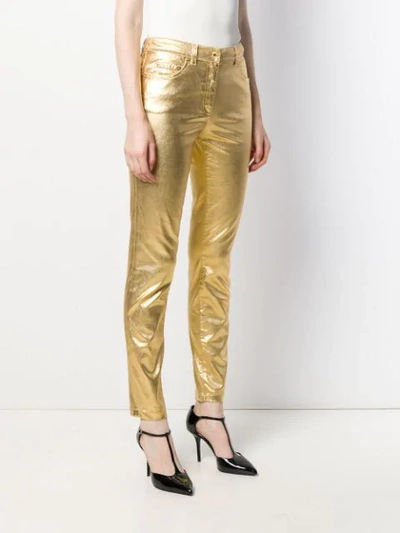 Shop Moschino Metallic Slim-fit Trousers In Gold